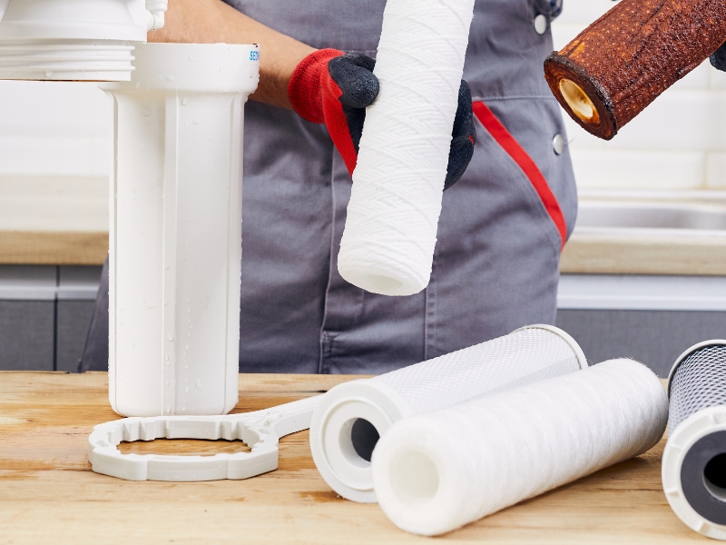 Technician fixing Zip Hydrotap Problems with dirty and new water filters