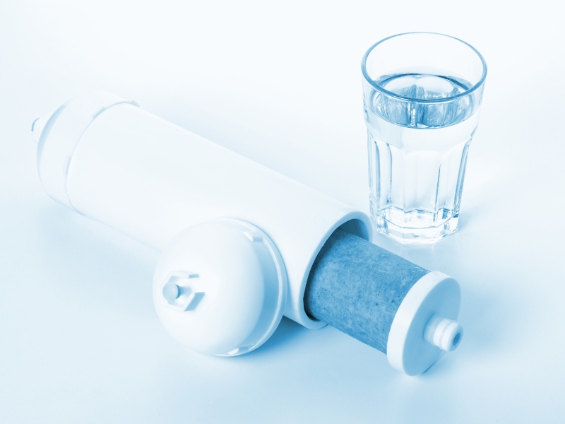 Zip Hydrotap Problems showing water filter cartridge and clean glass.